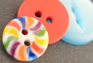 Three buttonsnext to each other close up in bright colours