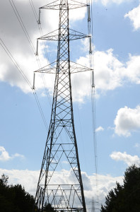 An electricity pylon seen almots overhead with a second small pylon in the distance