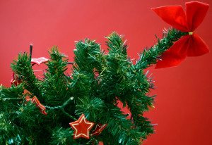 Artifical Xmas tree with red stars against a red background