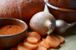Soup or stew ingredients on a table with teracotta bowls